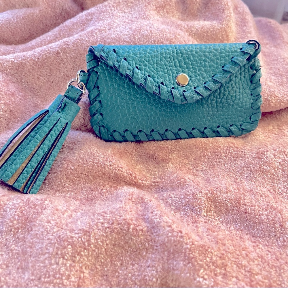 Small turquoise wallet with tassel.